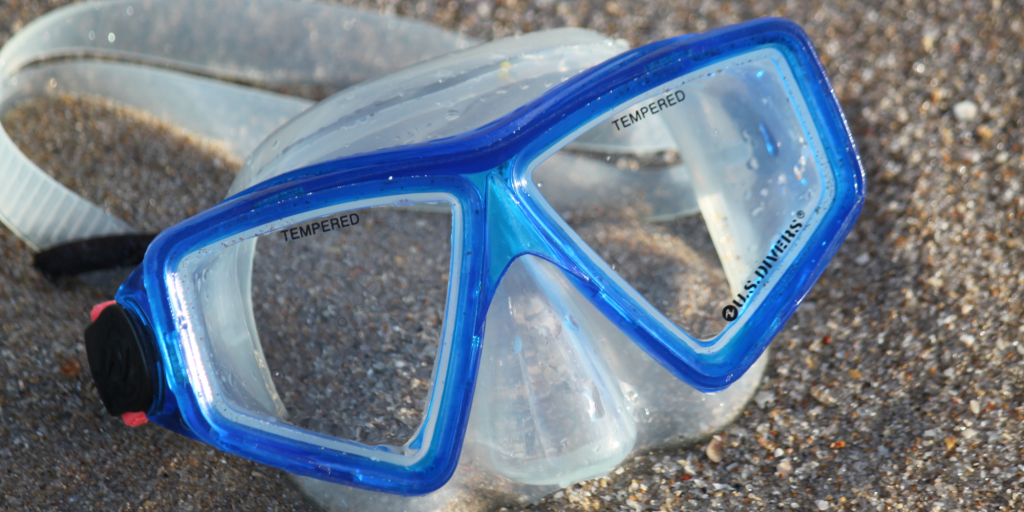 A swimming mask for children that is blue and clear and used for snorkelling